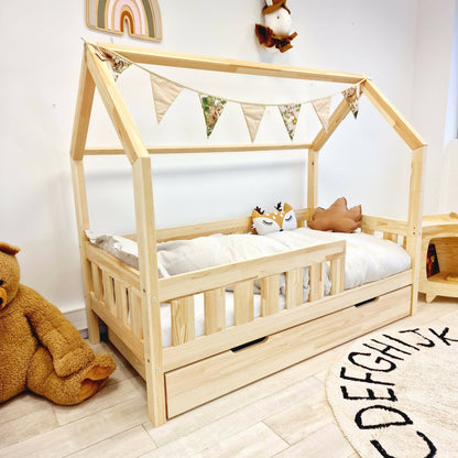 Cama de cabaña infantil con barreras con barras y cajones